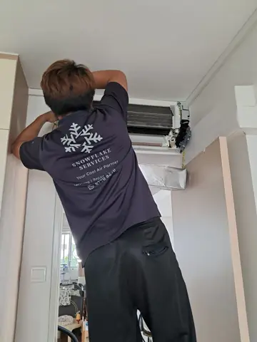 Technician servicing a wall unit