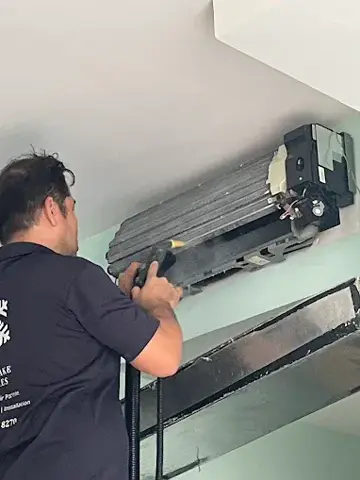 Technician working on an opened indoor unit