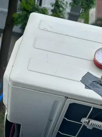 Pressure gauges connected to an outdoor unit during a gas check