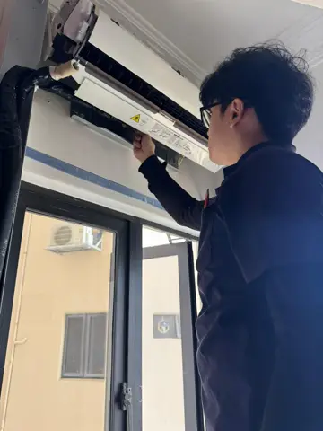 Technician opening up a wall-mounted unit